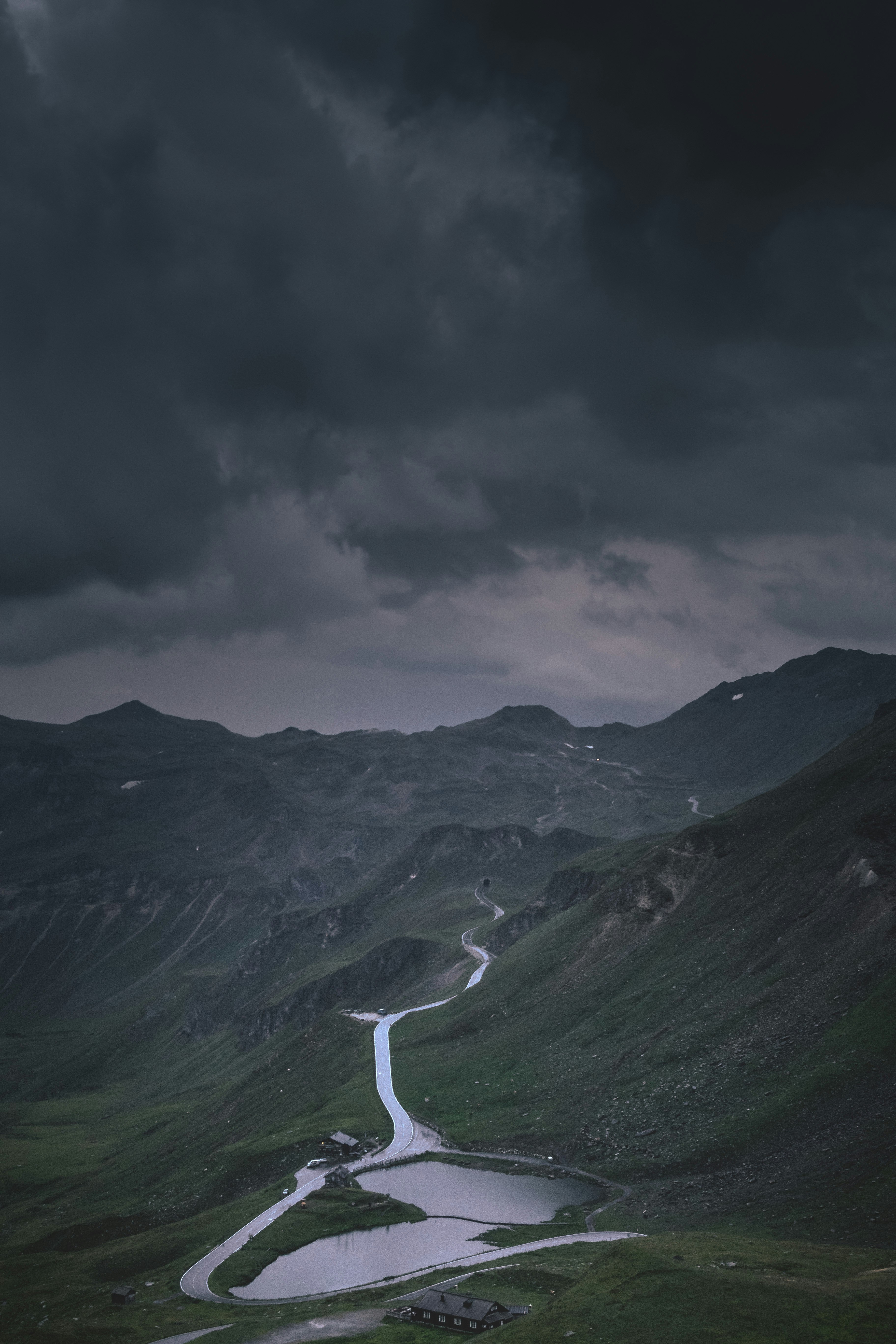 green mountains with body of water on bottom